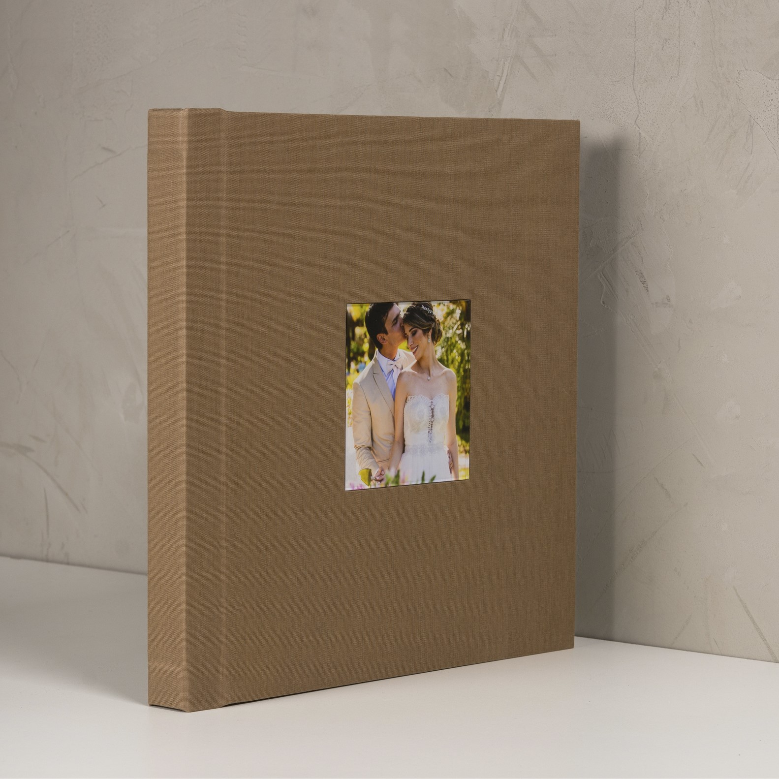 Casal de noivos em ensaio fotográfico ao ar livre, em um álbum de fotos personalizado.