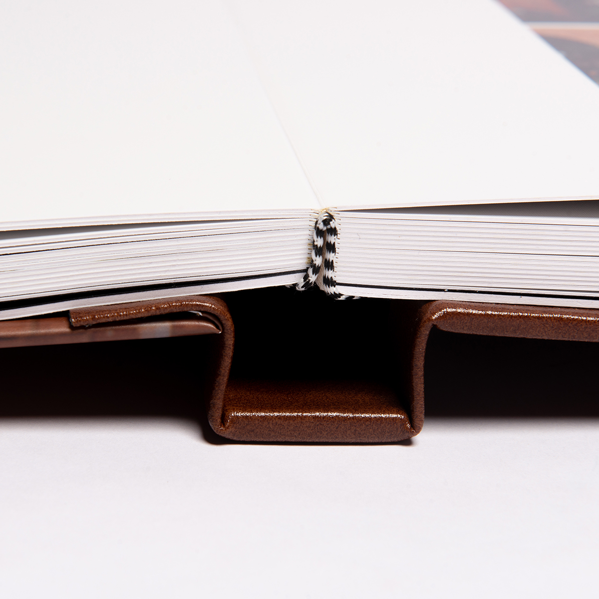 Árvore de livros aberta com páginas brancas e capa de couro marrom.